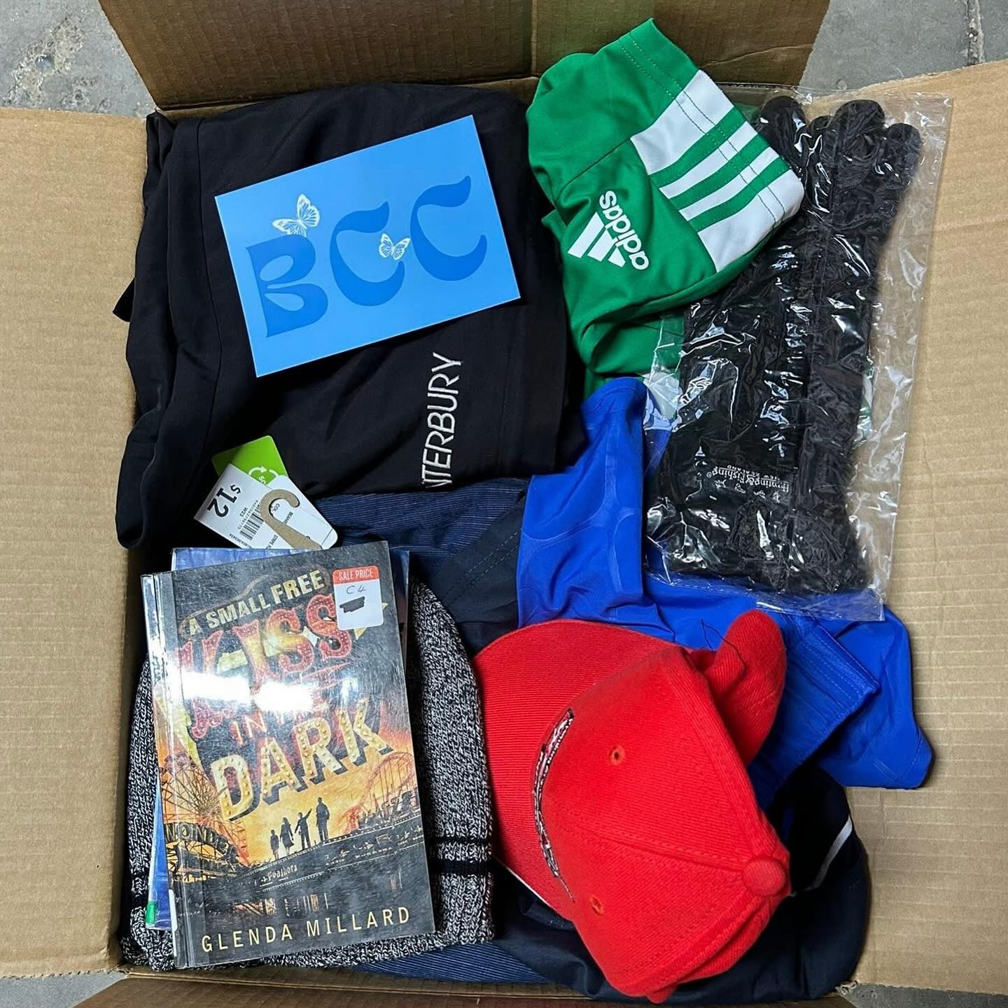 Donation sorting room with toys, clothing, and care pack items.